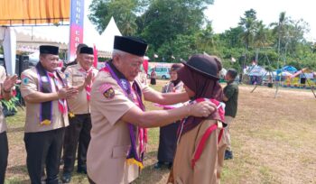 Ketua Mabicab Sofyan Kaepa menematkan tanda peserta jambore cabang Banggai Laut 2025 (Foto : Nomo/BanggaiTerkini)